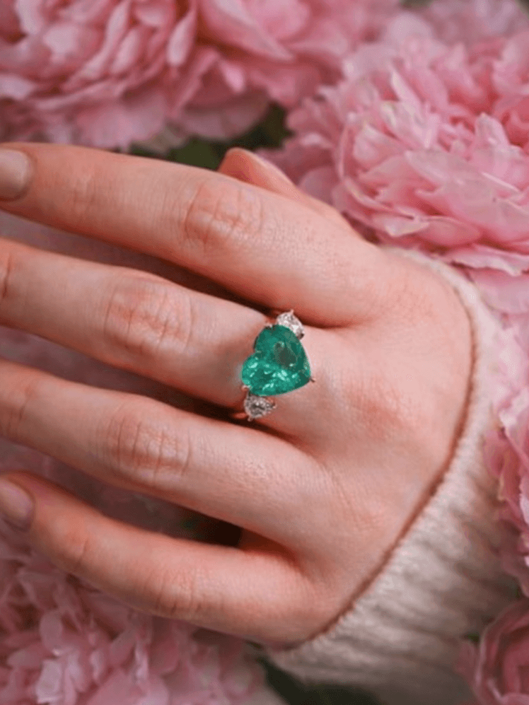 Image may contain Accessories Jewelry Gemstone Emerald Body Part Finger Hand Person Flower Plant and Rose